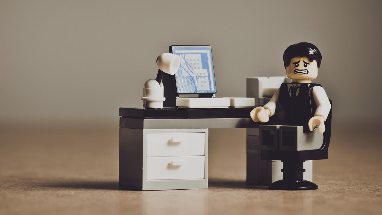 Avoid sadness! Know the rules before you sub-theme! Lego figure sitting at a desk with a look of despair on his face.